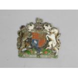 A painted early 20thC cast metal Royal Coat of Arms wall plaque, possibly for By Appointment, 18cm x