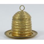 A late 19th/early 20thC gilt metal honey pot, formed as a beehive, the domed body with removable lid