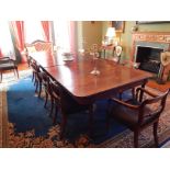 A George III mahogany extending dining table, the rectangular top with rounded corners and a