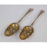 A pair of George II silver fruit spoons, with embossed fruit and engraved leaf decoration, maker