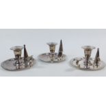 A set of three matched late 19thC silver plated taper sticks, each with compressed urn dish