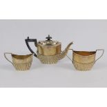 A Victorian silver three piece tea set, of semi fluted forms, John Howard Wilmot, Birmingham 1894,