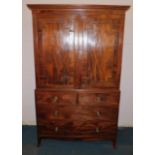 An early 19thC mahogany clothes press, the top with a moulded cornice above two panelled doors