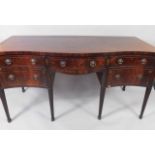 A serpentine sideboard, the top with chequer banding, above an arrangement of a central drawer,