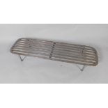 A large 19thC steel trivet, with slatted top and ball feet and poker, 108cm wide