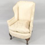 An 18thC mahogany framed wingback chair, of small proportion, with swept arms and cabriole legs,