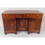A George IV mahogany sideboard, the rectangular top with a moulded edge, above two frieze drawers