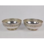 A pair of Indian bowls embossed with a band of flowers, stamped silver, 14.26oz.