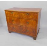 A walnut chest of drawers, with two short over two long deep drawers, raised on bracket feet,
