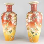 A pair of late 19th/early 20thC Japanese earthenware vases, each decorated with flowers, birds etc.,