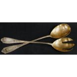 A pair of German white metal salad servers, each with tapering handles, engraved with the initial R,