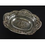 A late 19thC Continental white metal basket, cast centrally with putti, within a landscape with