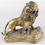 A cast brass model of a lion, on a stylised rock base, lacking plinth, 19cm wide