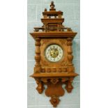 A late 19th/early 20thC German wall clock, in stripped oak case, with Arabic numbers, 103cm high