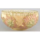 A Royal Worcester salad bowl, decorated with leaves on a blush ivory simulated basketware ground,