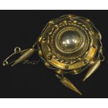 A Victorian silver gilt circular brooch, with safety chain, 3cm wide