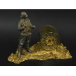 A novelty early 20thC time piece, modelled in the form of a first World War soldier on a gilt