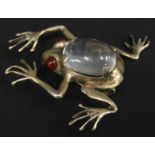 A frog brooch, with central clear glass stone body, with red glass eyes, white metal stamped