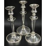 A pair of silver plated candlesticks, each with a beaded border and a similar example engraved