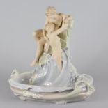 A Royal Dux porcelain centrepiece, modelled in the form of two nudes, coming out of waves etc.,