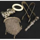 A collection of silver items etc., to include sugar tongs, small mesh purse, a child's rattle with