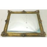 A gilt composition rectangular wall mirror, with pierced scroll decoration, 82cm high, 97cm wide