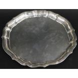 A German white metal salver, with a deep piecrust type border, stamped to the reverse Beumers