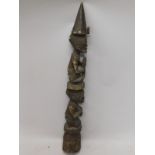 Tribal Art. A carved African bell, decorated with male and female figures, 79cm high