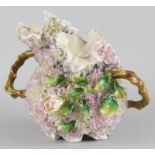 A Continental porcelain ewer, profusely flower encrusted with roses etc., impressed mark to