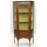 A late 19th/early 20thC mahogany display cabinet in the manner of Liberty, inlaid in copper and