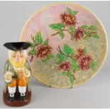 A Royal Doulton Chrysanthemum pattern plaque or charger, and a Royal Doulton Happy John toby jug (