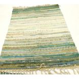 A large rag rug, another and other rugs