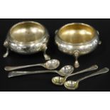 A pair of Victorian silver salts, each on three legs, with bright decoration, partly engraved,