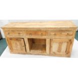 A 19thC pine dresser, with three frieze drawers above a dog kennel, flanked by two panel doors on