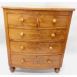 A late Victorian mahogany bow fronted chest, with two short and three long drawers, on bun feet,