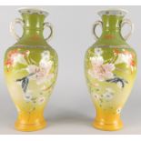 A pair of late 19th/early 20thC Japanese earthenware two handled vases, each decorated with