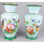A pair of Paris porcelain vases, each decorated with flower sprays on a pale blue ground, 33cm high