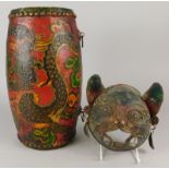 Tribal Art. An Eastern drum, painted with dragons etc., and a metal wall mask depicting a cat