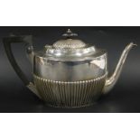 A late Victorian silver oval teapot, with half fluted body, ebonised knop and handle, London 1891,