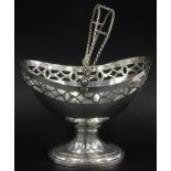 A white metal oval basket with a pierced border and rope twist swing handle, marks indistinct, 8¾