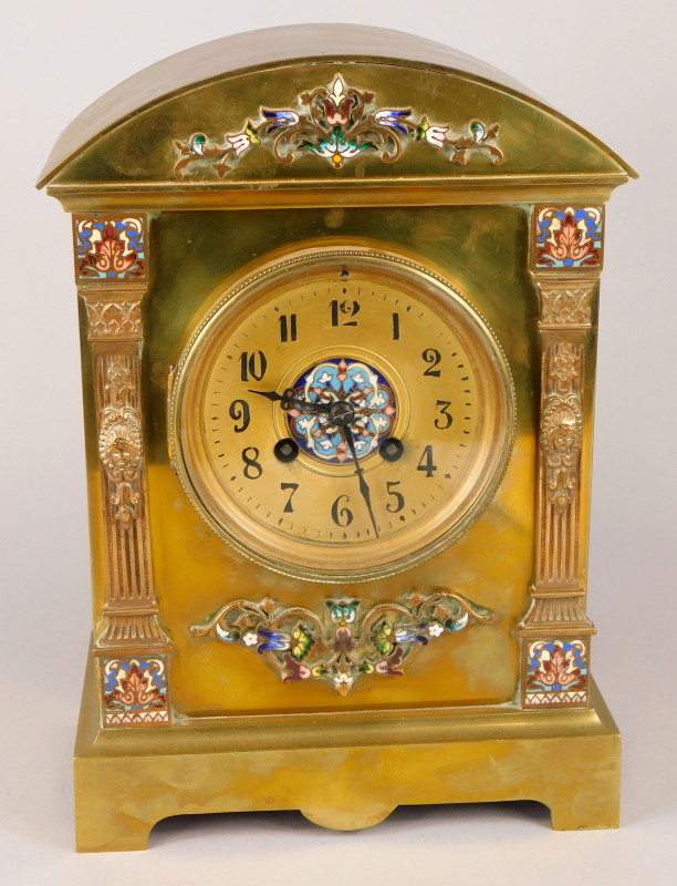 A late 19thC French brass and champleve enamel mantel clock, the arched case applied with foliate