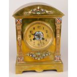 A late 19thC French brass and champleve enamel mantel clock, the arched case applied with foliate