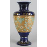 A Royal Doulton Slaters patent vase, decorated with flowers in gilt within cobalt blue borders,
