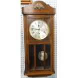 A 1920's mahogany wall clock, with Westminster chime and silvered dial, 79cm high