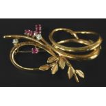 A 9ct gold floral bar brooch, with swirl designed set with garnet and white stones, 5cm wide.