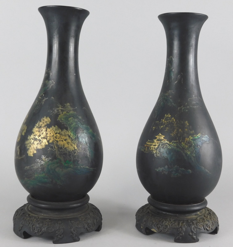 A pair of oriental lacquer style vases, decorated with river landscape, boats etc.