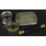 A collection of small silver, to include two napkin rings, a cigarette case, and a blue glass double