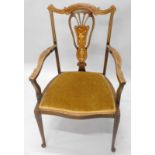 An Edwardian mahogany and marquetry open armchair, with a pierced splat, padded seat, on square