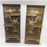 A pair of oriental style brown and gold lacquer wall brackets, each decorated with dragons and