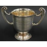 A George V silver two handled cup, engraved presented by Alderman W Lacey J.P, C.C to the Louth